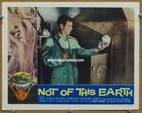 z636 NOT OF THIS EARTH movie lobby card '57 holding skull image!