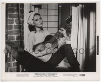 1h044 BREAKFAST AT TIFFANY'S 8x10 movie still '61 Audrey Hepburn sitting in window playing guitar!