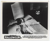 2d102 HALLOWEEN 8x10.25 still '78 great image of girl laying in bed with tombstone & jack-o-lantern!