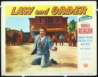 4c412 LAW & ORDER movie lobby card #2 '53 man in suit & tie kneeling on ground in center of town!