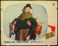 4c847 THIS GUN FOR HIRE LC '42 close up of Alan Ladd in trenchcoat carrying fainted Veronica Lake!