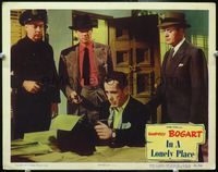 4f689 IN A LONELY PLACE LC #7 '50 three policemen hold guns on Humphrey Bogart at typewriter!
