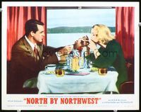 7r578 NORTH BY NORTHWEST LC #5 R66 Cary Grant lights Eva Marie Saint's cigarette while eating!