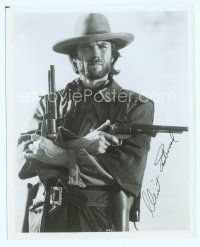 7c028 CLINT EASTWOOD signed 8x10 publicity photo '80s great cowboy portrait holding two big guns!
