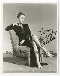 7y041 BARBRA FULLER signed 8x10 REPRO still '80s seated in sexy dress showing off her legs!