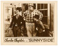8t689 SUNNYSIDE LC R20s Charlie Chaplin in Tramp suit by a large man & a small man!
