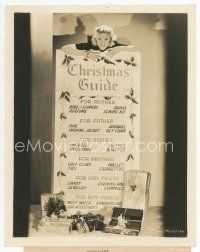 9j705 UNA MERKEL 8x10 still '30s standing over a gargantuan Christmas Guide for shoppers!