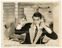 7w469 LADIES SHOULD LISTEN 8x10 still '34 great close up of Cary Grant on phone & holding gun!