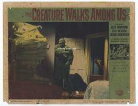 9d329 CREATURE WALKS AMONG US LC #7 '56 full-length image of the monster busting through doorway!