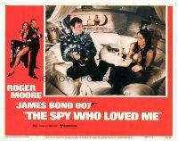9d821 SPY WHO LOVED ME LC #5 '77 Barbara Bach holds Roger Moore at gunpoint he's opening champagne