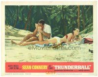 9d888 THUNDERBALL LC #5 '65 Sean Connery as James Bond on beach biting sexy Claudine Auger's foot!