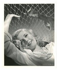9r058 ANITA LOUISE 8x10 still '30s laying down smiling by netting & wearing pearls!