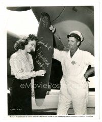 5d283 DEANNA DURBIN 8x10 still '43 close up signing a P-38 plane propeller for Lockheed employee!