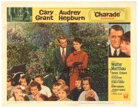 5m314 CHARADE LC #6 '63 Cary Grant looks at Audrey Hepburn standing behind lots of children!