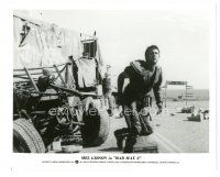 8k605 MAD MAX 2: THE ROAD WARRIOR 8x10 still '82 great image of Mel Gibson by truck on road!