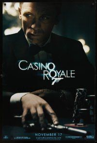 9w093 CASINO ROYALE teaser 1sh '06 Craig as James Bond sitting at poker table w/gun!