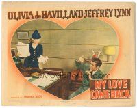 9y688 MY LOVE CAME BACK LC '40 Olivia de Havilland holding papers at desk is angry at Jeffrey Lynn