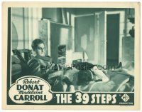 2h050 39 STEPS LC R38 Alfred Hitchcock, c/u of Robert Donat & dead Lucie Mannheim on bed!