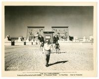 3k877 TEN COMMANDMENTS 8.25x10.25 still '56 Cecil B. DeMille walks in desert in front of huge set!