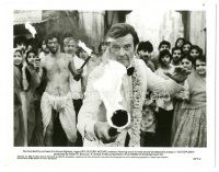 5k687 OCTOPUSSY 8.25x10 still '83 Roger Moore as James Bond wield a flaming torch in crowd!