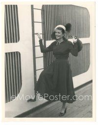 5k755 RITA HAYWORTH 6.75x8.5 still '48 posing with a smile by ladder on ship heading to England!