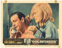 6h387 GOLDFINGER LC #2 '64 c/u of sexy Shirley Eaton behind Sean Connery as James Bond on phone!