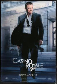7d422 CASINO ROYALE DS bus stop '06 Daniel Craig as James Bond outside casino with gun!