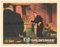7d067 GOLDFINGER LC #4 '64 Sean Connery as James Bond about to throw stick at Harold Oddjob Sakata