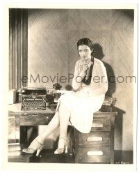 8h520 KAY FRANCIS 8.25x10 still '30s full-length c/u sitting on desk with pen held to her mouth!