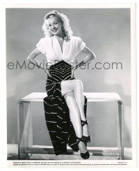 9y179 CAROLE LANDIS 8.25x10 still '44 sitting on wooden table in wonderful deco outfit!