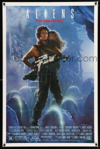 2f043 ALIENS 1sh '86 James Cameron, Sigourney Weaver as Ripley holding Carrie Henn!