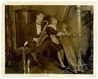 2z847 STAN LAUREL 8x10 still '28 as a butler playing a saxophone by a maid playing a harp!