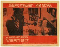 3t316 VERTIGO LC #5 '58 Alfred Hitchcock, standing James Stewart on phone,blonde Kim Novak in bed!