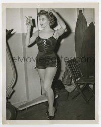 4m584 MARILYN MONROE 7x9 news photo '52 checking makeup in swimsuit from We're Not Married!