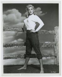 4m473 JAYNE MANSFIELD 8x10 still '50s standing by fence in trousers w/rolled cuffs & tight sweater