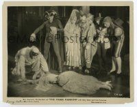 6a802 THREE PASSIONS 8x10 still '28 great image of people in costume by dead woman, Phantom-like!