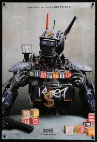 7r117 CHAPPIE teaser DS 1sh '15 close up image of the robot with toy blocks, huge necklace and gun!