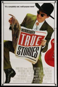 7r778 TRUE STORIES 1sh '86 image of star & director David Byrne reading newspaper!