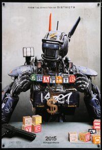 8k137 CHAPPIE teaser DS 1sh '15 close up image of the robot with toy blocks, huge necklace and gun!