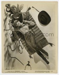 9h746 RENEGADES 8x10.25 still '46 sexy Evelyn Keyes laying down with horse riding gear!