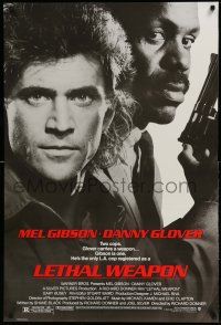 1w472 LETHAL WEAPON 1sh '87 great close image of cop partners Mel Gibson & Danny Glover!