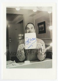 2d0657 JOHN CLEESE signed 6x8.25 REPRO still '90s holding a piece of paper in his mouth at vanity!