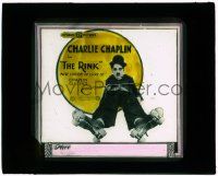 6d095 RINK glass slide R20s great image of Tramp Charlie Chaplin on ground with roller skates!