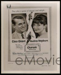 7a446 CHARADE presskit w/ 2 stills '63 tough Cary Grant & sexy Audrey Hepburn, cool poster art!