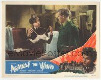 7c253 AGAINST THE WIND LC #2 '49 uniformed Simone Signoret shows man the bra in her suitcase, Ealing