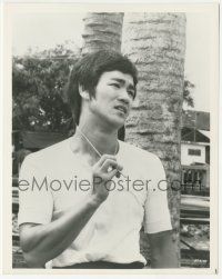 7d359 FISTS OF FURY 8x10.25 still '73 c/u of Bruce Lee looking upset & holding his necklace!