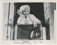 7d805 SEVEN YEAR ITCH 8x10 still '55 classic image of Marilyn holding shoes at apartment window!