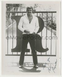 7x1200 BURT REYNOLDS signed 8x10 REPRO still '75 full-length posing by the gate of his home!
