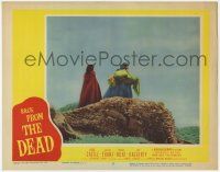 8f411 BACK FROM THE DEAD LC #7 '57 far shot of robed man carrying unconscious Peggy Castle!