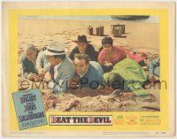 1k595 BEAT THE DEVIL LC #6 '53 Humphrey Bogart & cast members cowering & laying in sand on beach!